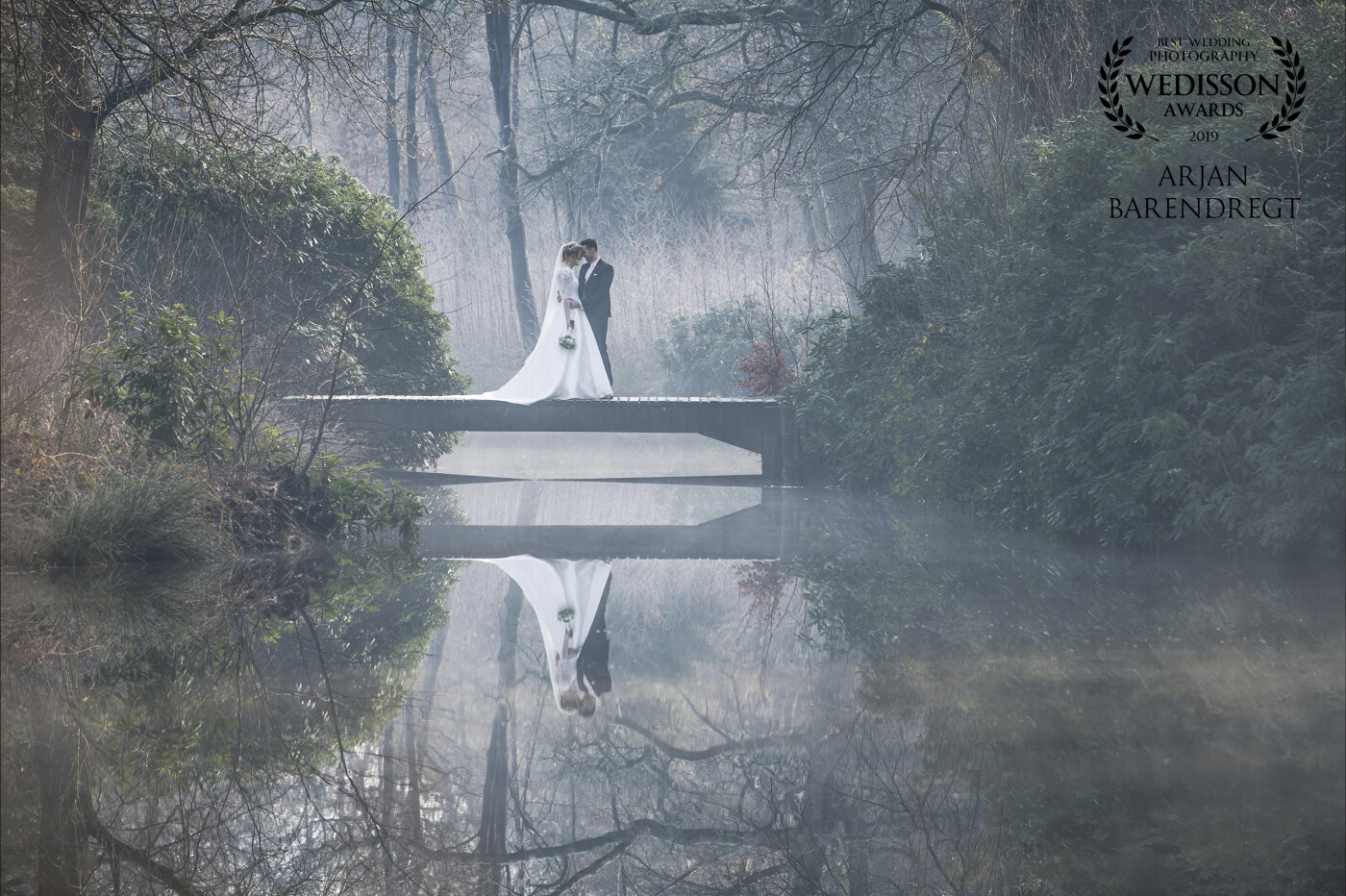 This lovely couple took us to a beautiful place near Rosmalen (Netherlands). It was the first wedding of 2019.<br />
We started the shoot early in the morning. The grass and leaves were all covered with ice. <br />
The couple had a special connection with this small bridge. Years ago the bride was sure, if she ever gets married she would have a picture on this bridge. So there it is... 