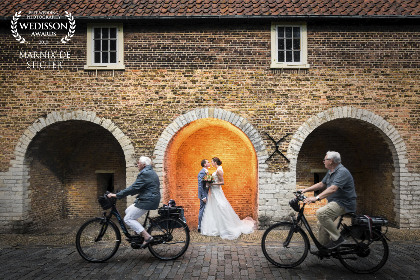 Taken in the beautiful old center of Delft, the Oostpoort is a favorite place for couples to pose during their wedding day. Since there were many people biking there and I wanted to do something a little different this idea quickly came to mind. It only took a few shots to get it right with the timing of the elderly couple.