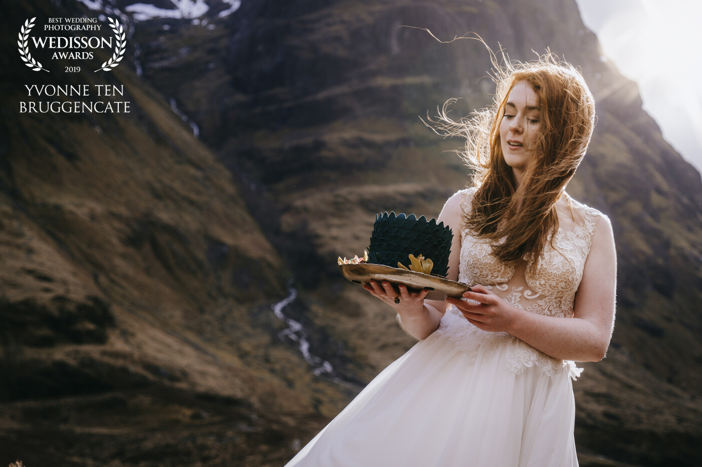 This is beautiful Emma in the mountains of Scotland. It was taken at ‘the three sisters’ a beautiful spot at Scotland highlands with three mountains. We had to run for the rain showers several times. It was freezing cold, but Emma wanted to go on, to get the most beautiful wedding pictures. And when the sun popped out the magic happened 