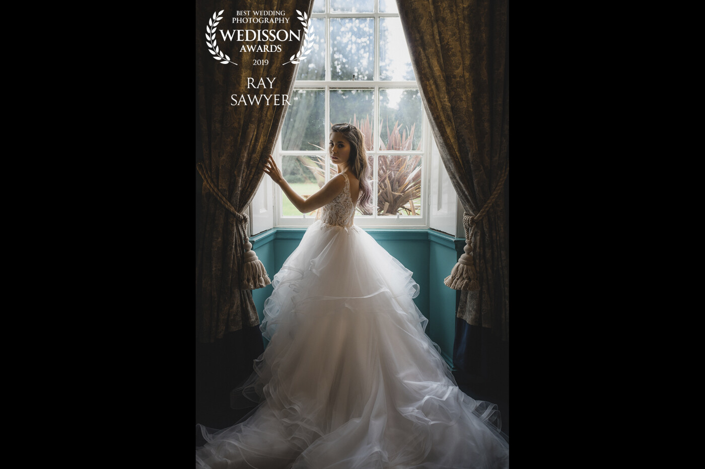 Jaime-Lee showcasing her beautiful wedding dress at Hallgarth Manor in Durham. The window frames her beautifully and the curtains provide a natural symmetry!
