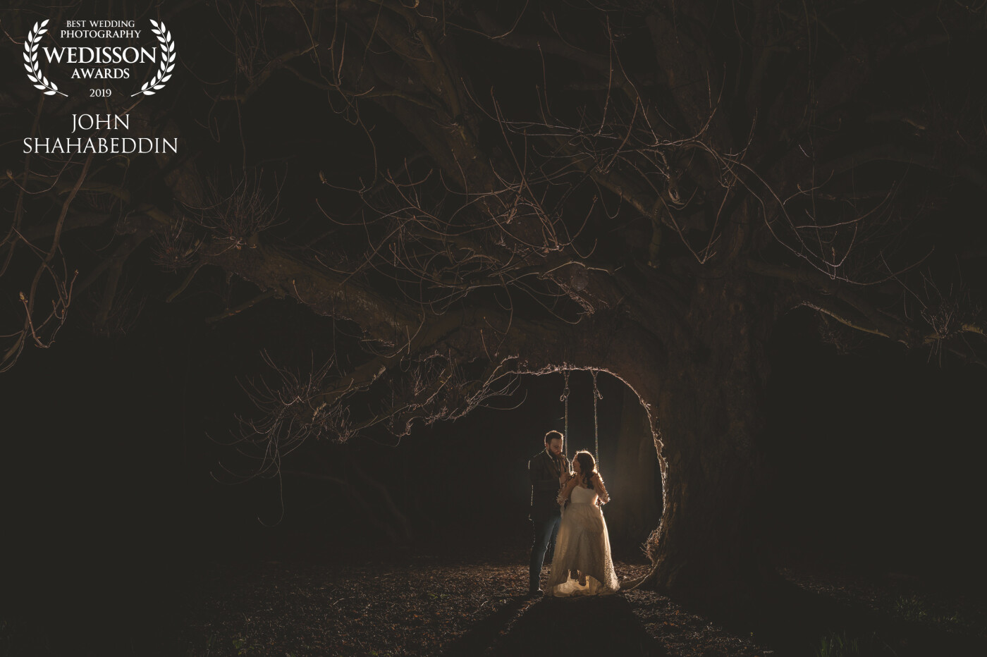 Whilst out during the day exploring the woodland at Shotton Grange, a small North East country house wedding venue, the couple and I came across a beautiful ancient chestnut tree with a lovely old rope swing, and I just knew we'd have to come back after dark to capture a stunning nighttime portrait. The image is lit with two speedlights, one behind the couple, and one off-frame to the left on low power to illuminate the canopy of the tree. This was by far my favorite shot of the whole wedding, full of drama and eerie beauty.
