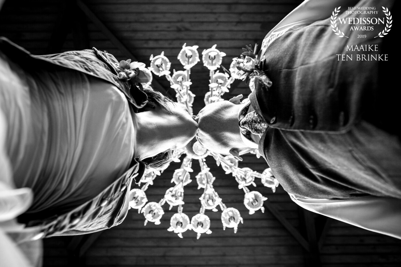 On this stunning wedding-location, Onder Ons Dalfsen, hangs a beautiful chandelier. I lay down on the stairs and asked the lovely couple to give each other a kiss. That's when I shot this picture! Very happy with it! 