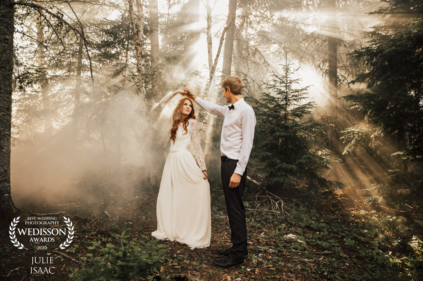 We photographed this couple nestled within the gorgeous forest surrounding Elk Ridge Resort, SK. We wanted to create a magical fairytale atmosphere for their first dance. As the sun slowly lowered in the sky, its rays were gently captured by the smokey haze hanging in the trees, adding to the romantic feeling in the air. 