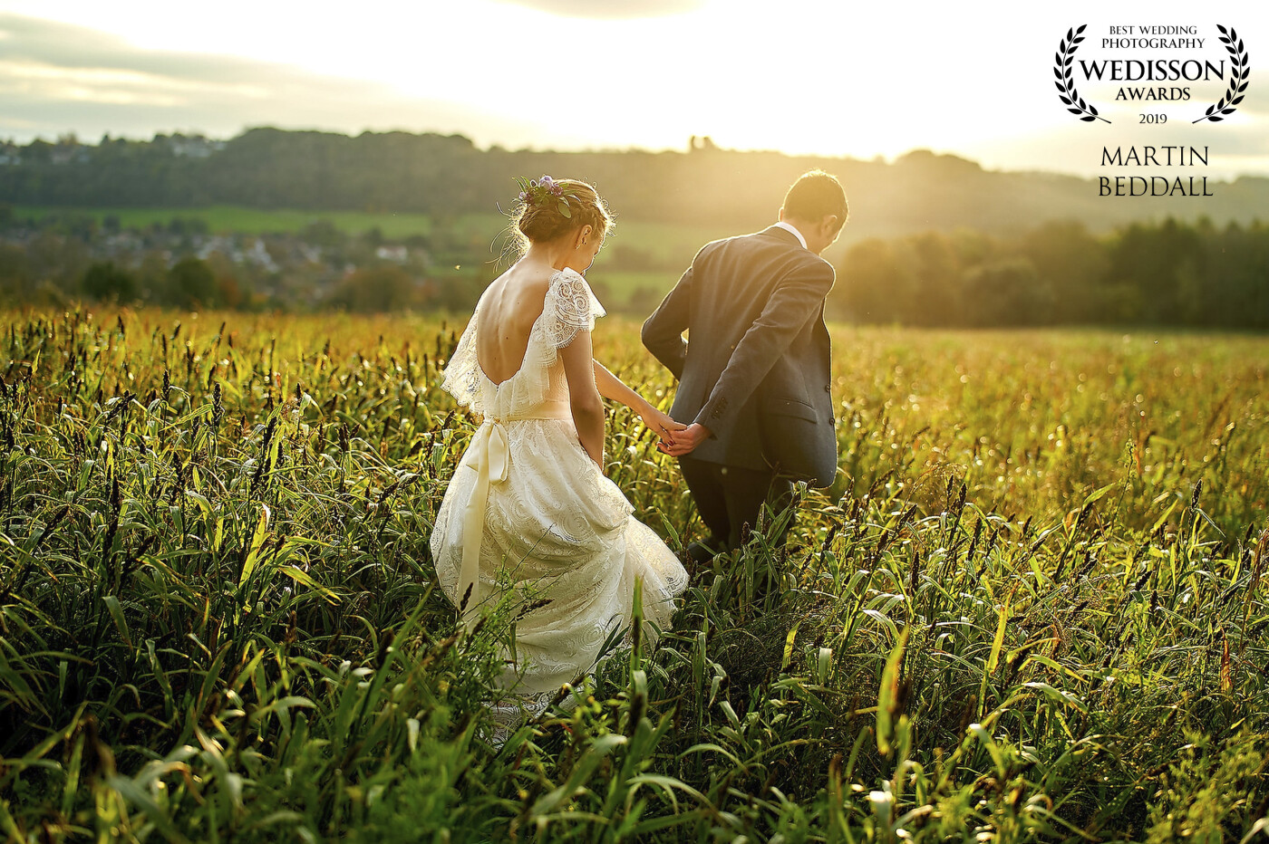 An October wedding at Cissbury Barns in West Sussex, UK. Anna and Daniel had popped out for a quick picture with the setting sun, but the best picture was as they walked to their spot. Unprompted Daniel took Anna's hand.