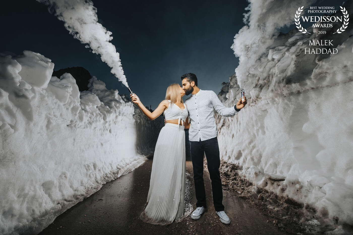 Pre-wedding photo shoots are my favorite because the pictures would always turn out to be spontaneous. We saw this snowy path on our way to the location. I remembered we had white smoke so I just made them stand there in the cold to take the picture. With the smoke, the location and their clothes, I had the perfect combination.