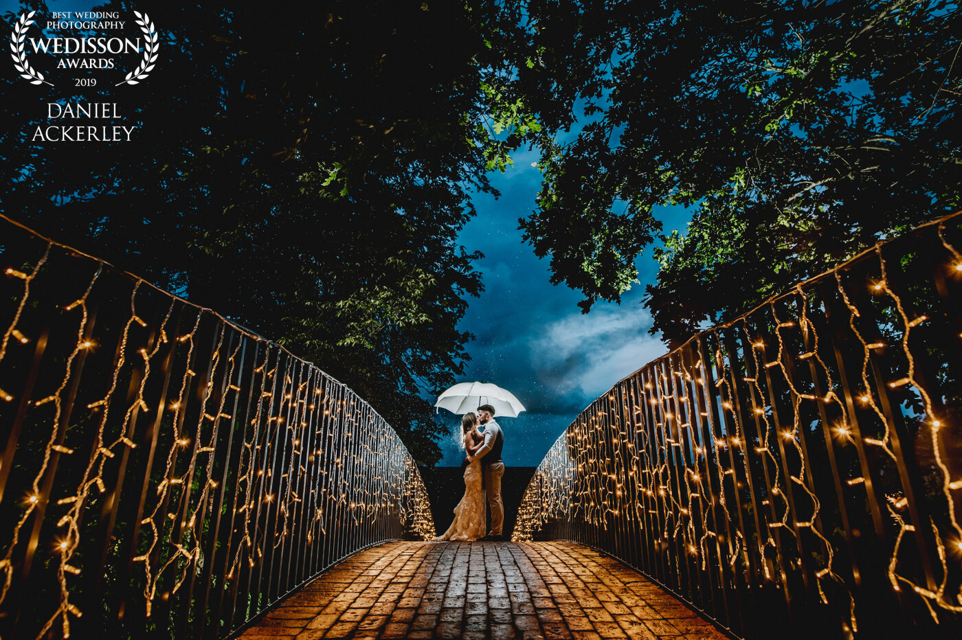 It had rained all day long at the venue, but towards the end of the night it became just drizzle, so we nipped out and used the beautiful bridge lights as a lovely setting for this portrait.