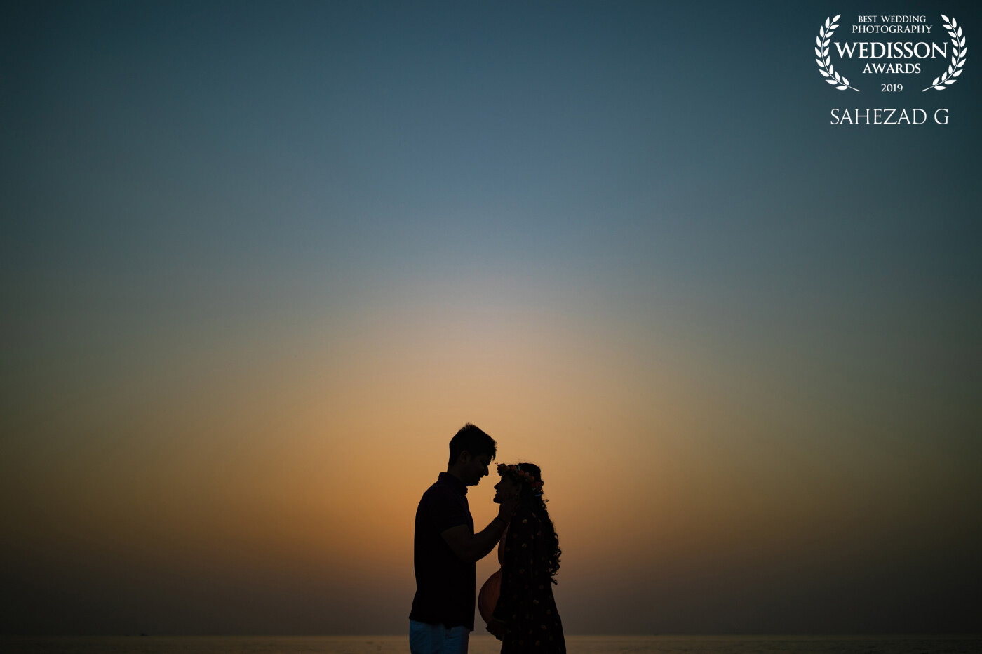 We were at the Suhali beach capturing couple first maternity shoot Ravi & Garima. This was the second shoot with the couple after their wedding photography.<br />
The couple was tired and ask for pack up, as we were shooting the third session of the day. Ask them for the last shoot of the day. Just tried to add the combination of pre weeding in a maternity shoot. The sun was ready to set. Used profoto light for the shoot. This is the result.