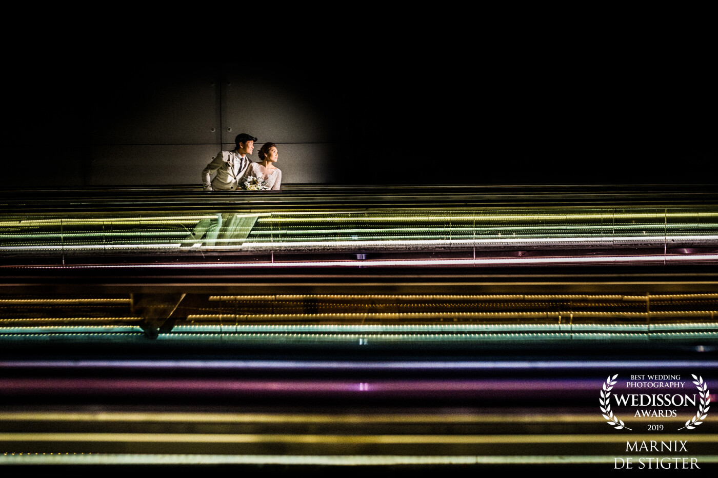 During this pre-wedding shoot, we came along this long escalator with funky colors. As they went up and I went down we had to time exactly when would be the best moment. Using flash they got isolated from the surrounds which adds an extra pop to the image! :)