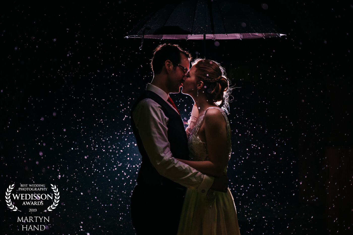 Louise and Sam had been in and out of the intermittent rain all day. When the heavens finally opened to give us a biblical downpour, they decided to fully embrace it and we caught something beautiful. I decided to gel the flash behind them just give the image a different look to most rain shots