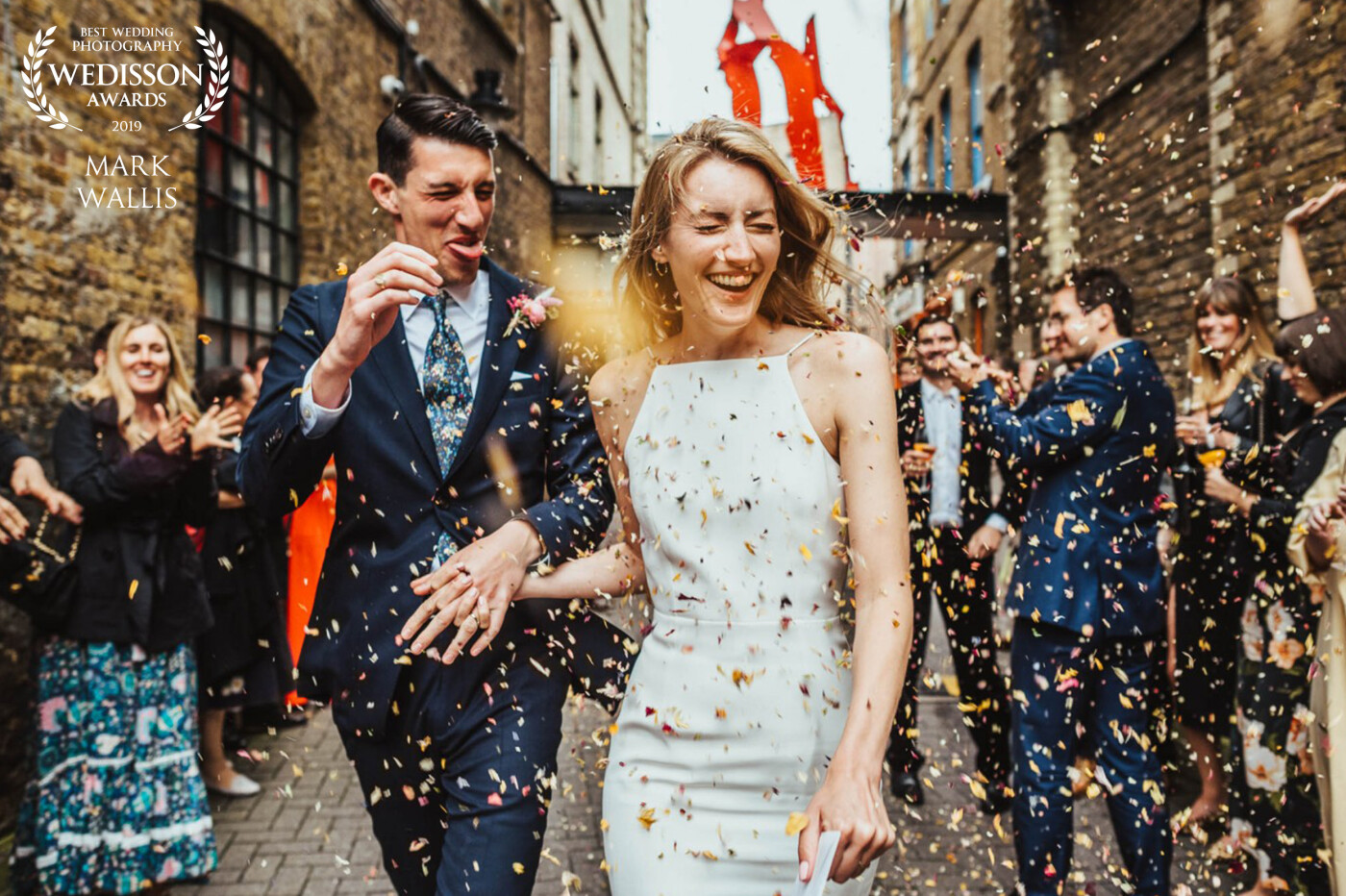 This was Liv & Matt's second lot of confetti having chosen to run the gauntlet again at the start of their evening reception at First Option Location Studio in Hackney, London. Matt is experiencing the downside to the combination of a big, open-mouthed smile, and light and floaty biodegradable confetti.