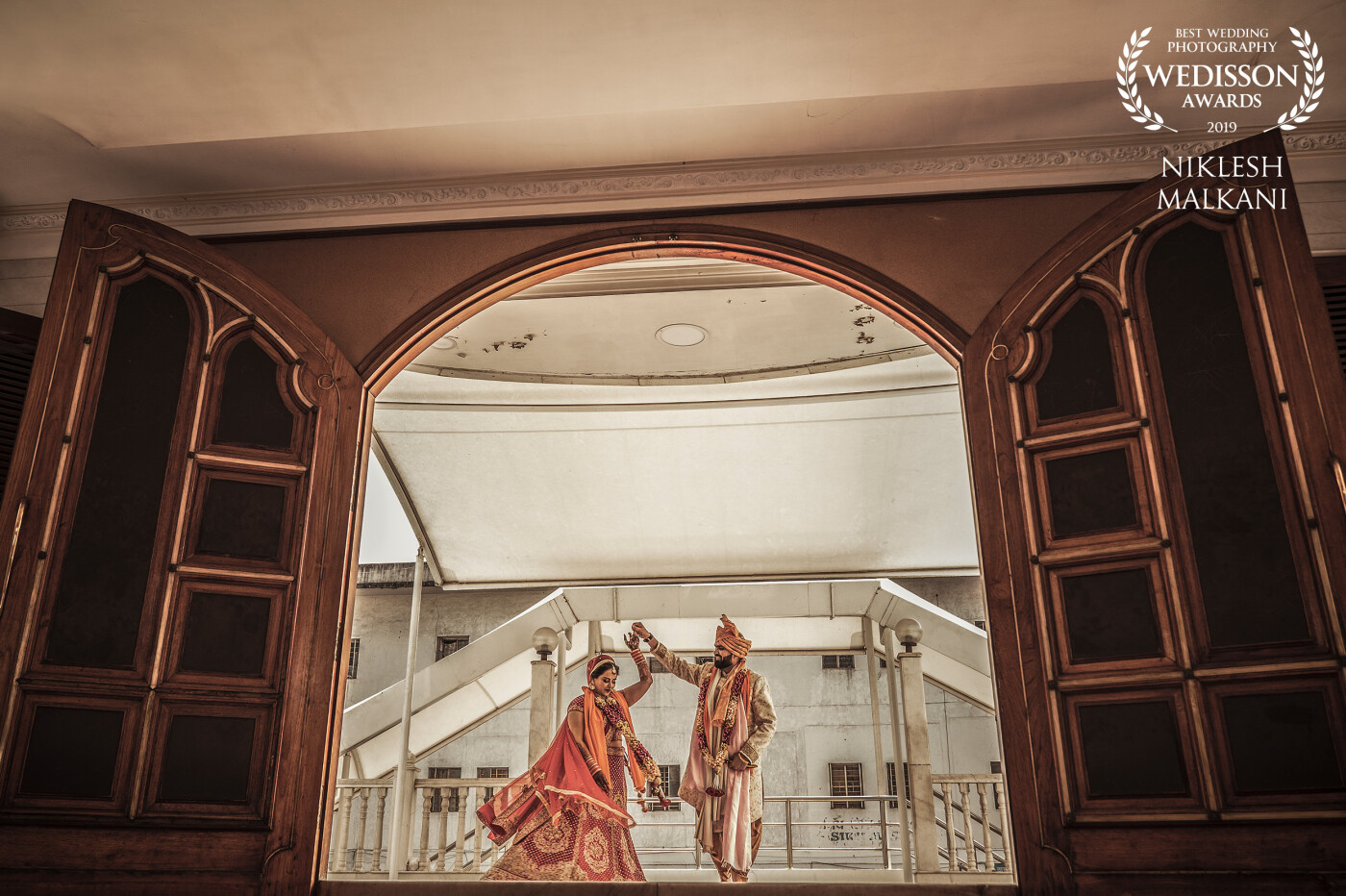 This was shot at a Gurudwara at Pune city, Maharashtra. Just after the wedding, we wanted a few couples of portraits and saw this gorgeous entrance door. I told the couple to walk and do a small twirl at the end. That was the final shot.
