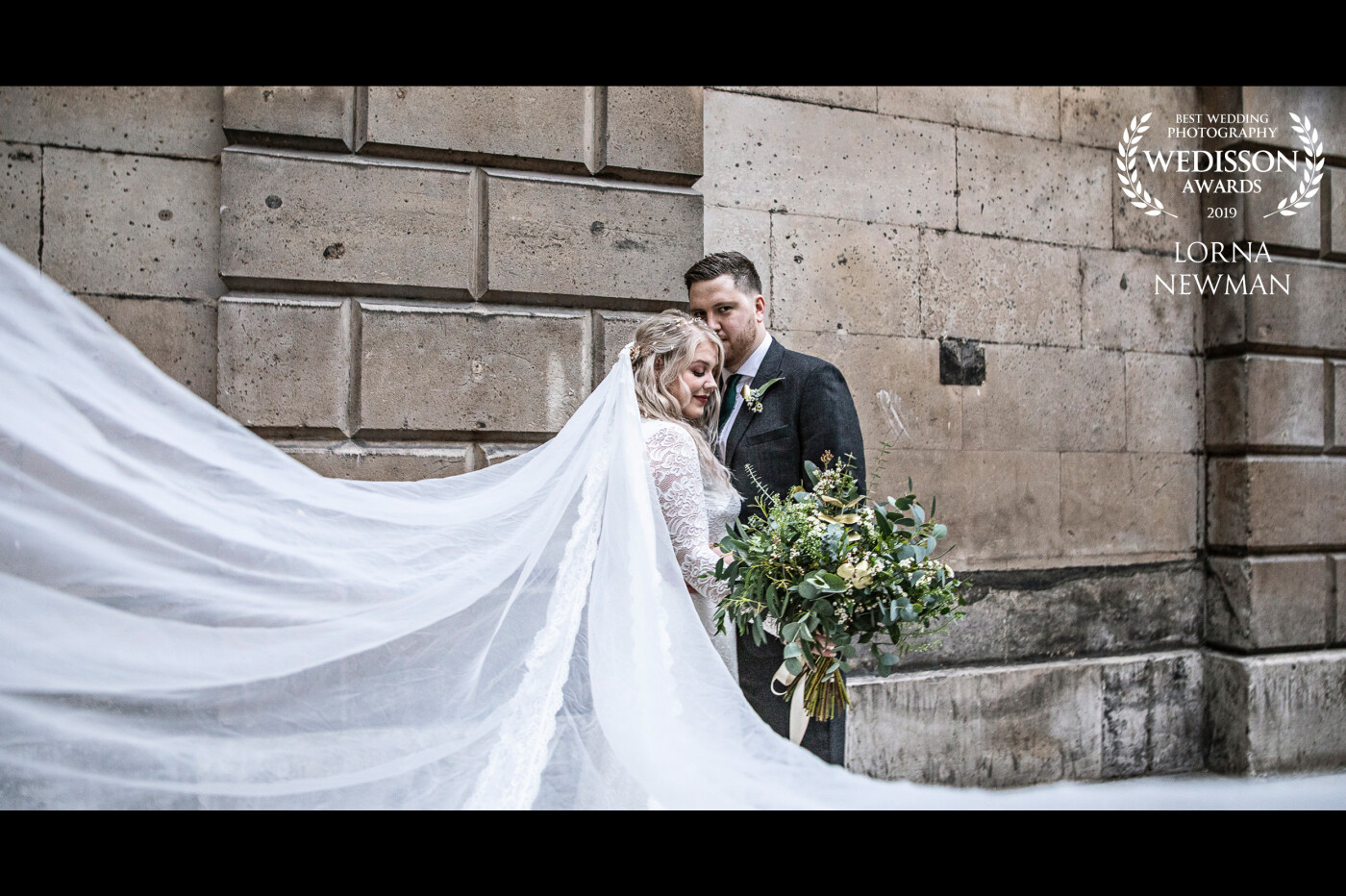 This shot is from Katy & Matt's beautiful Christmas wedding in central London. <br />
We only had a few moments to pop out at dusk before we lost the light to capture this beautiful moment between Katy & Matt right after they got married, check out Katie's beautiful wedding veil. 