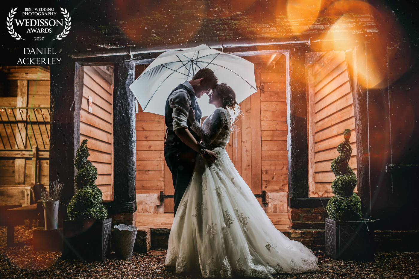 I captured this portrait of Marcus & Emily during a light rain shower here in the UK, using the water on my lens to add a little magic to the scene, and it worked a treat with the lighting from my flashguns and the venue.