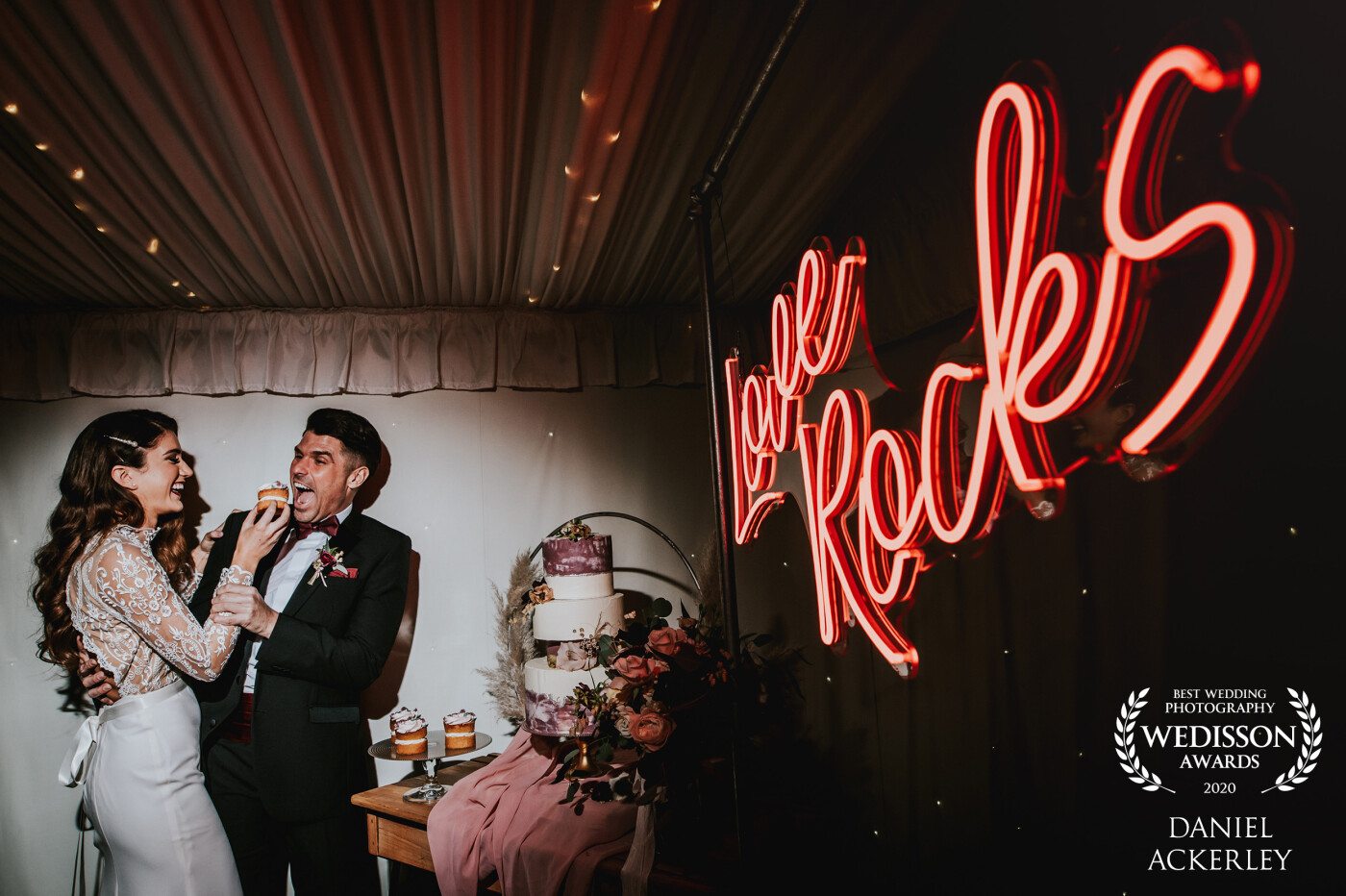 This photograph of Silvanna & Tom was captured at Chippenham Park in the UK, I really wanted to make sure the Love Rocks neon sign was properly exposed, so before the cake cutting I put a light up to expose the couple and not spill onto the sign, and it worked perfectly! The fact they were messing about just made the moment even better :-)