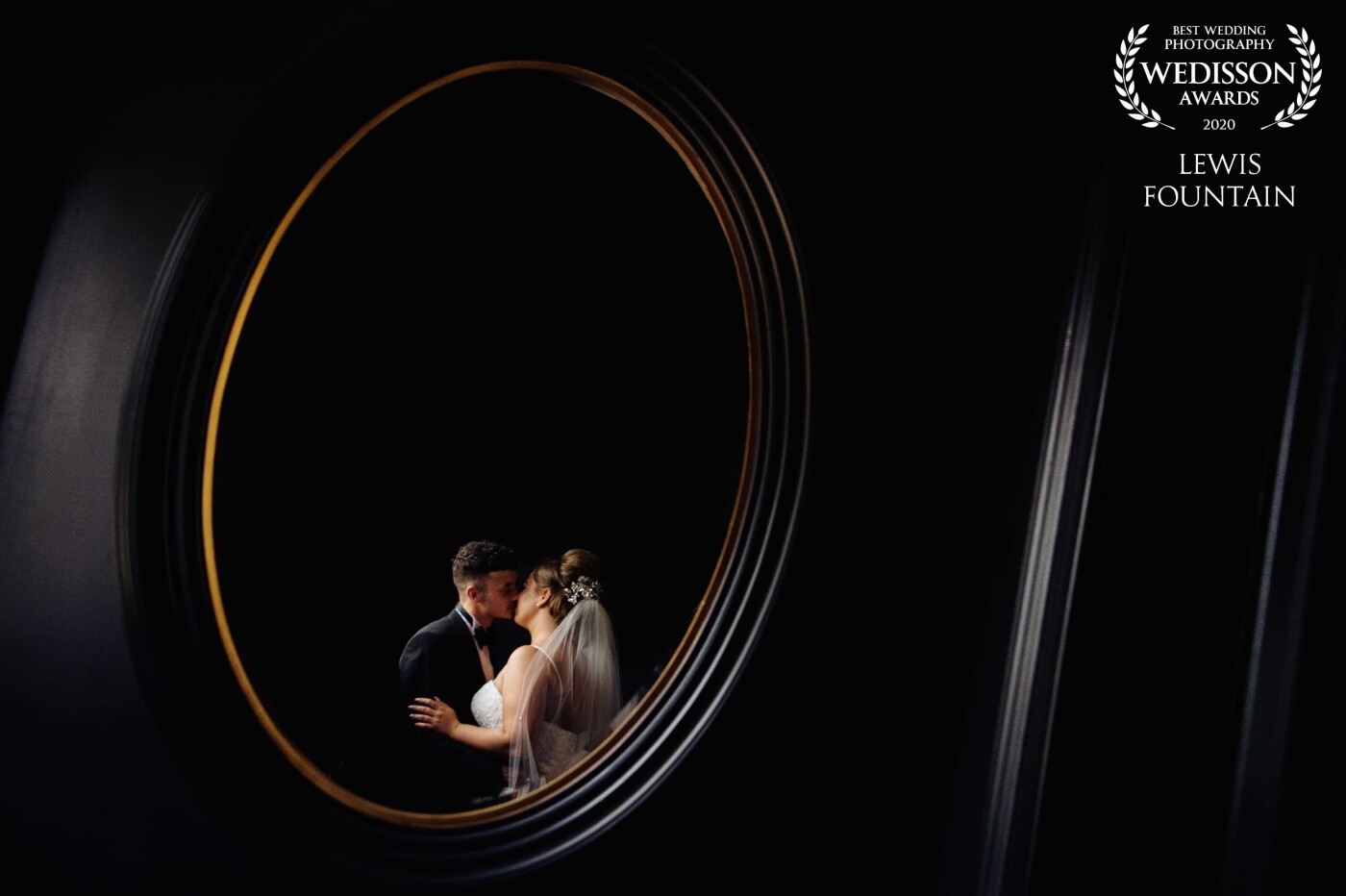 This image was captured at the beautiful Swynford Manor near Newmarket. <br />
The couple said they wanted something arty of the two of them captured within the venue. We decided to use one of  Swynford's big mirrors, combining this with a little cross lighting from a nearby window worked perfectly at creating something a little different yet still keeping to the dark contrast of the venue.