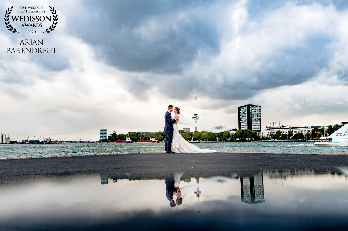 This lovely couple married in Rotterdam.: one of the biggest cities in the Netherlands. And they wanted to capture the skyline on their wedding pictures. And we succeeded... Left we see the cranes of Rotterdam Harbor, at the right Rotterdam Spido, and in the center De Euromast (Euromast Tower). <br />
This is really Rotterdam! 