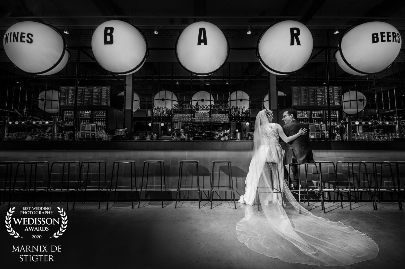 During the photoshoot, it was so windy outside that we had to find shelter in a local bar. This place created a fitting scene for one of my favorite shots of the day. Fun fact was that they actually had met in a bar, so this added extra meaning to the image.