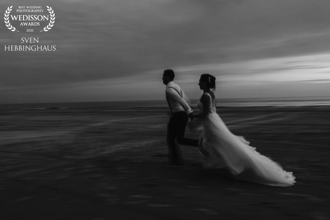 This photo was taken at the beach of Fanø (Denmark). It was a wonderful wedding in the last summer on this small island. While turning down the shutter speed this photo I love the motion in this picture. 