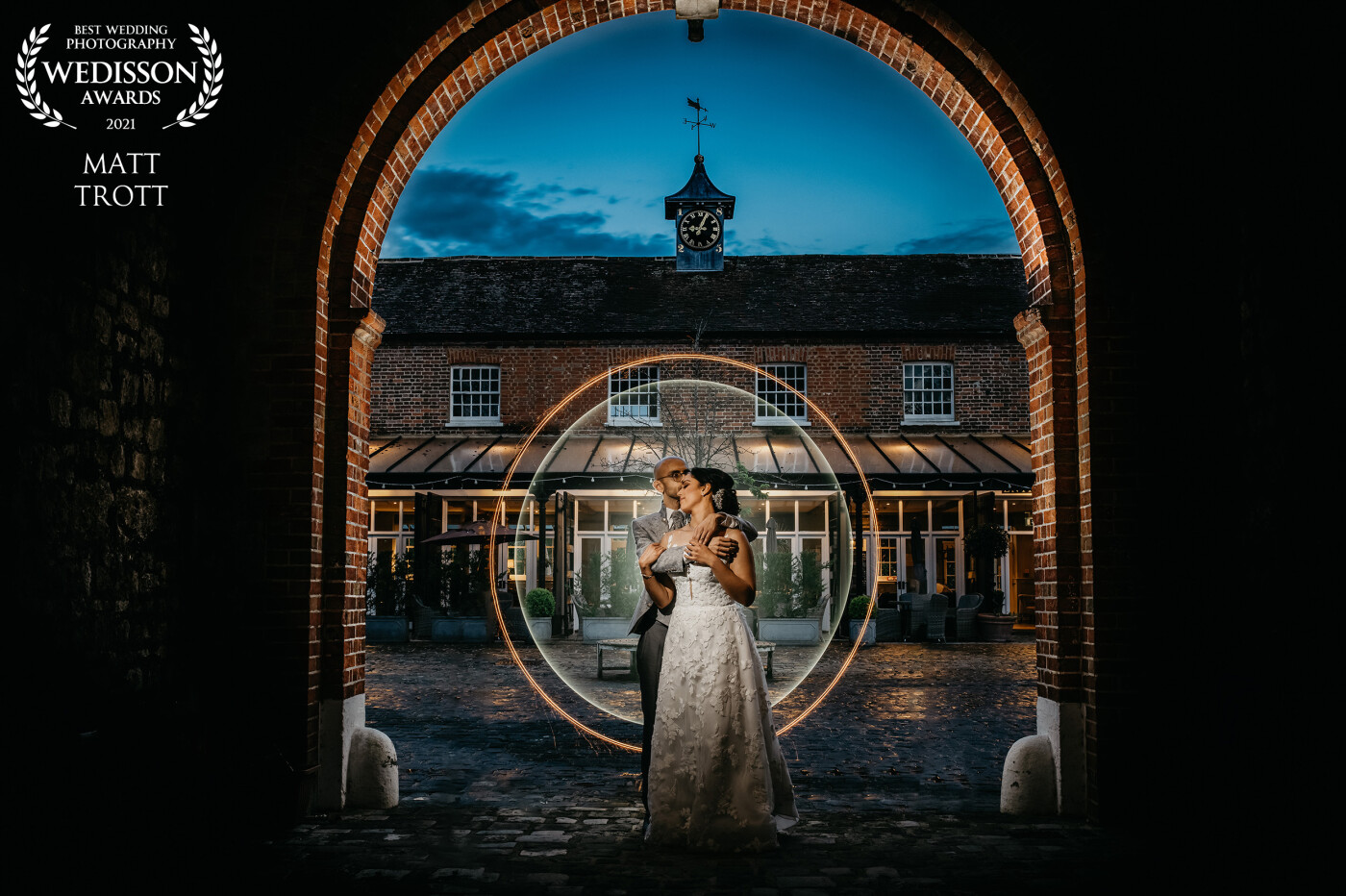 This photo was taken at the secret garden in kent, UK. The couple came back after the wedding so we can spend some extra time getting them something amazing. <br />
I had a flash with mag grid on the couple and two flashes pointing up at the archway to highlight it. The circle was created with one of my light painting tools. 