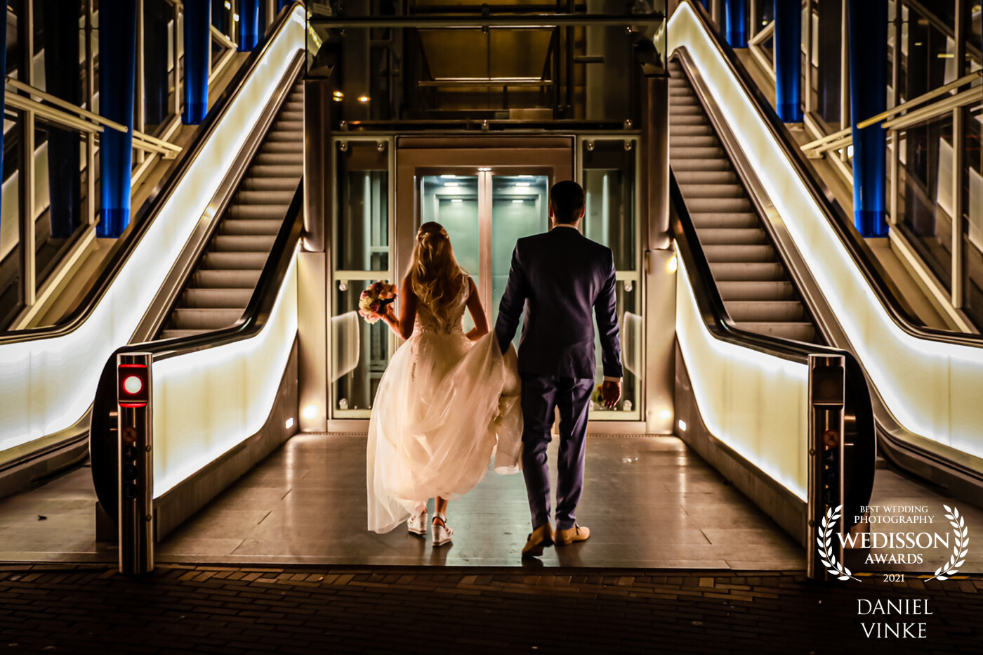 While we were traveling to the bridge for the photoshoot this lovely couple walked to the elevator. I was walking behind them and thought the lines and lighting were very nice here too. Then the groom picked up the train of the dress from the floor and that was just perfect!