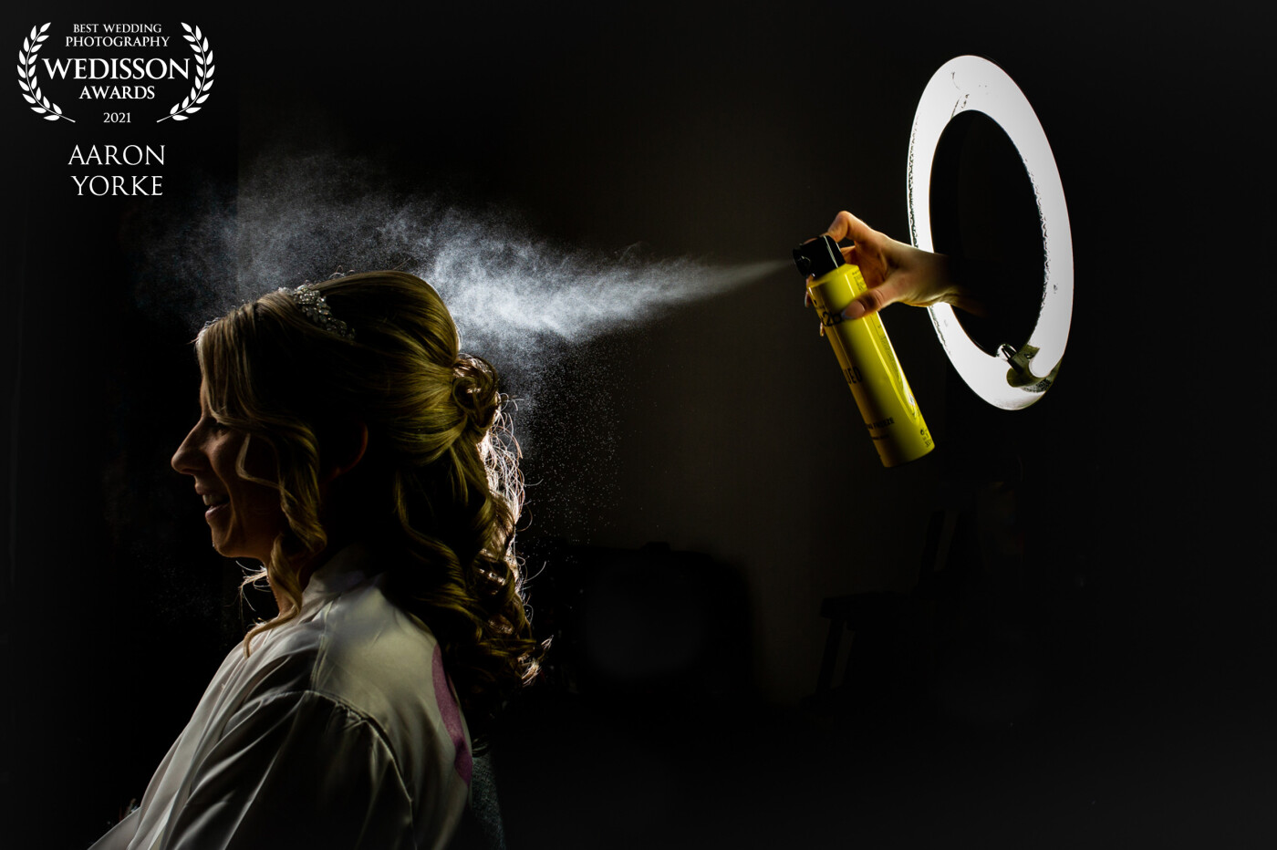 I was inspired to create a hair spray shot with a difference. So using the make-up artists ring light I asked her to placed her had through and spray. I love the yellow can and using a light to capture the spray behind the bride was a great way to black out the rest of the room.