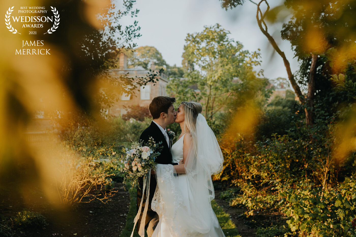 This photo of Richard & Emily was taken within the incredible grounds at Weston Park, Staffordshire in the UK. Their wedding was mid September and golden hour fell at the perfect time! The trees were beginning to turn for Autumn, and coupled with the amazing golden light, shooting through the trees, this image fell into place perfectly!
