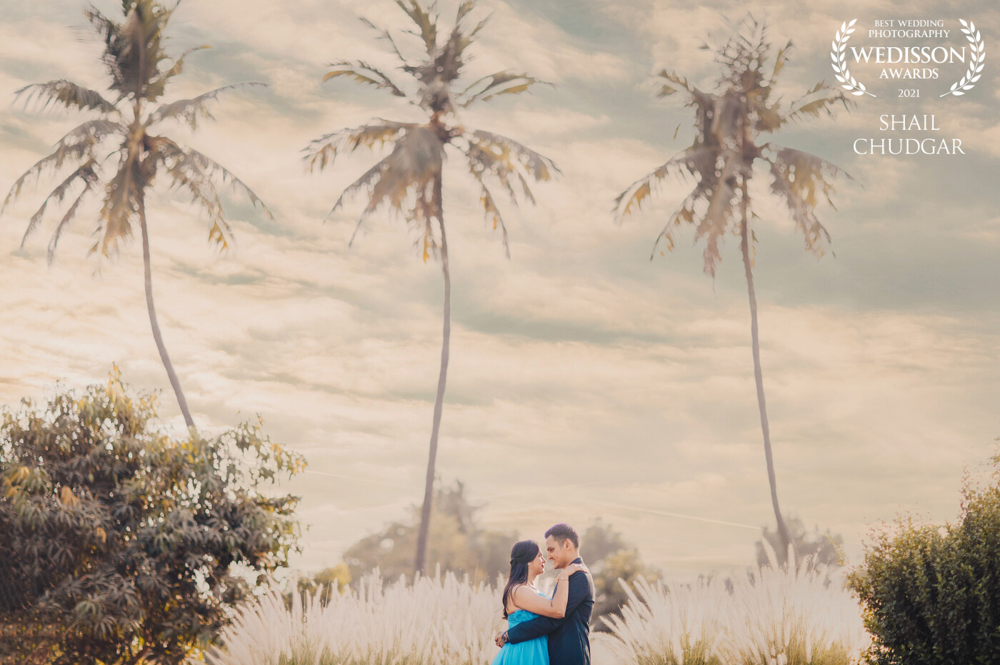 A mixture of a dramatic sky, swaying palm trees, greenery and the lovely couple looking into each others eyes! Romance + Drama all in one!