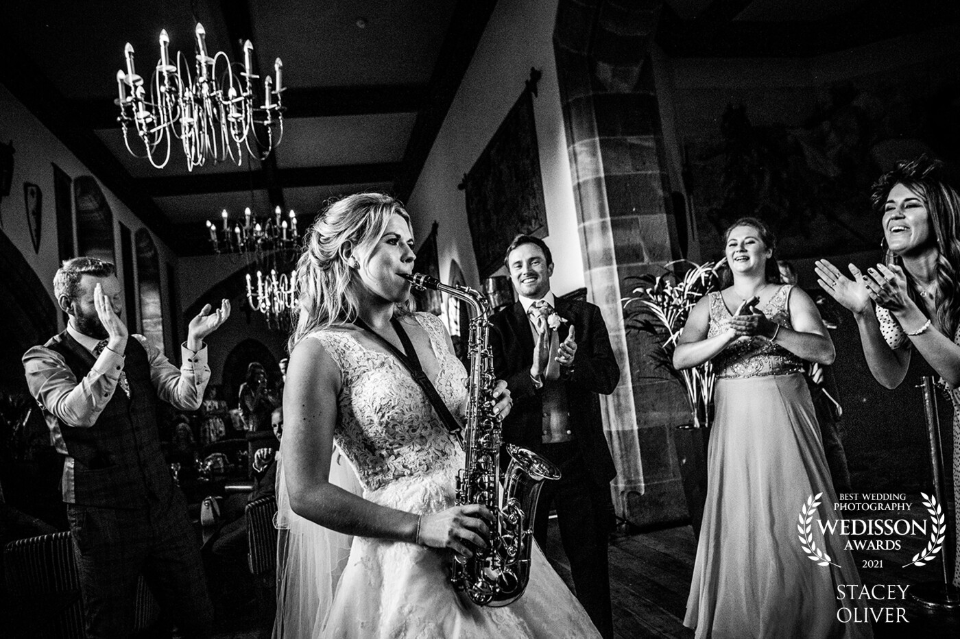 This bride Emily decided to entertain her guests by playing the saxophone. The venue Peckforton Castle in Cheshire was the perfect backdrop,  her guests and husband had a huge surprise.