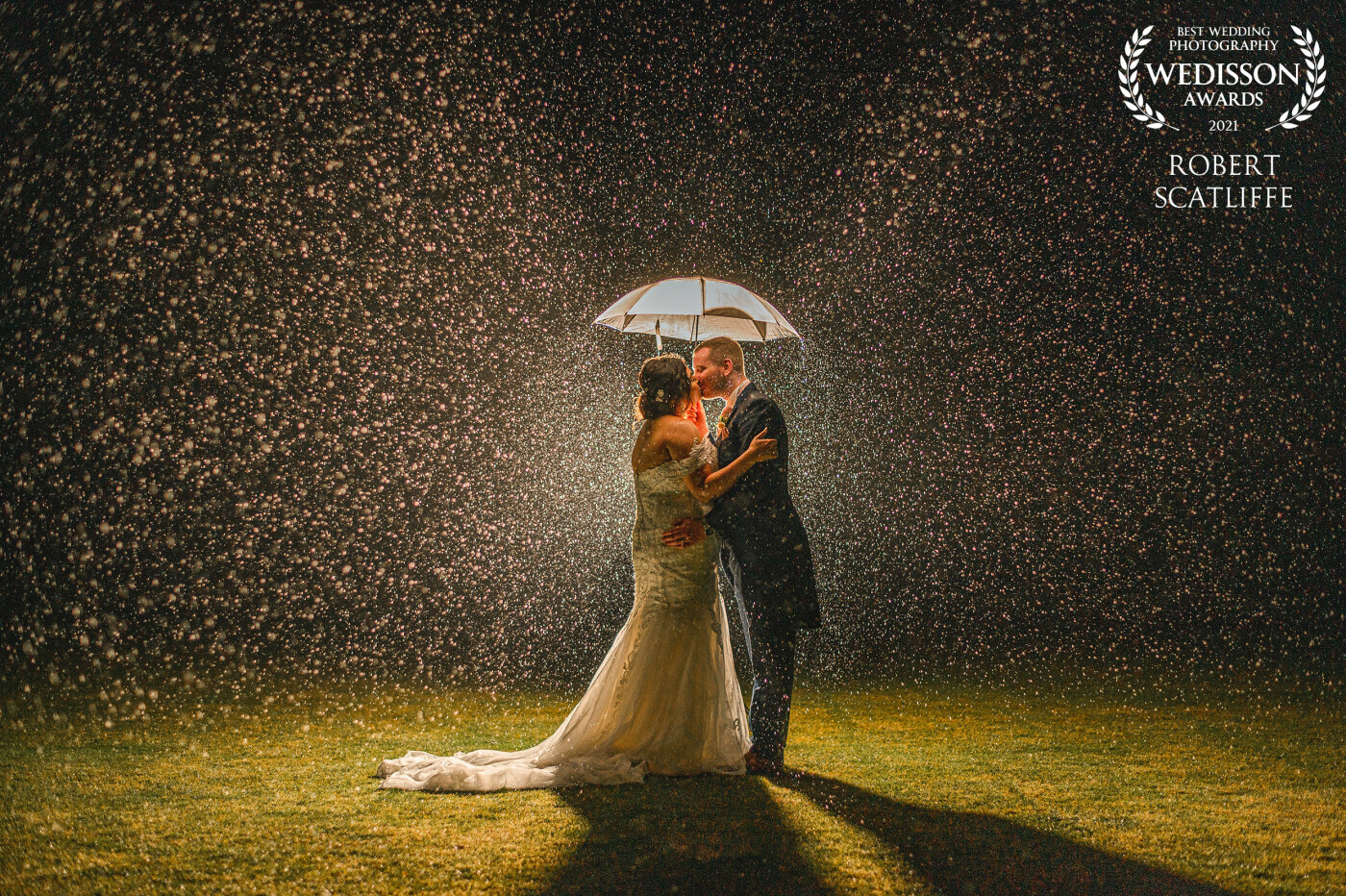 I had just finished their sparkler photos when the heavens opened ! luckily the Bride & Groom didn't mind getting a little wet to help me capture this .