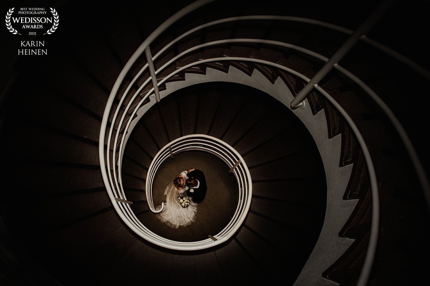 A great couple on a great day demands a great setting for their wedding pictures. Actually this specific setting was not part of the plan at all, but like we all know...Great surprises can have great advantages! <br />
<br />
We discovered this lovely curved stairway at the town hall of a small village somewhere in the South of The Netherlands.  Here this couple spoke their vows and said their 'legal' Yes I do's! After the ceremony they posed for like 1 minute at this great spot and then moved on for the rest of the program. So glad we took this opportunity.<br />
<br />
We are very pleased with this 17th Wedisson. Thanks to you all!