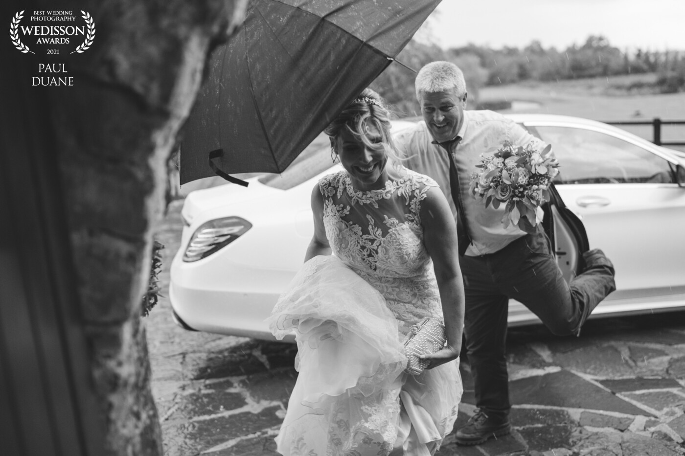 Our beautiful bride making a run for it to shelter from the rain, it was a gorgeous summers day and then the heavens just opened! That's the unpredictable Irish weather for you but they went on to have an amazing day and didn't let the rain dampen their special day.
