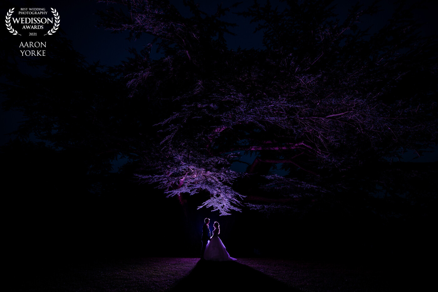 I shot this at a beautiful venue in Gloucestershire called Dumbleton Hall. There is this amazing tree I wanted to use as a silhouette shot. I used a purple get with 2 flash guns on full power. I placed them about 3 metres away from the tree to capture as much of the tree I could and the couple stood about 1 metre in front. ????