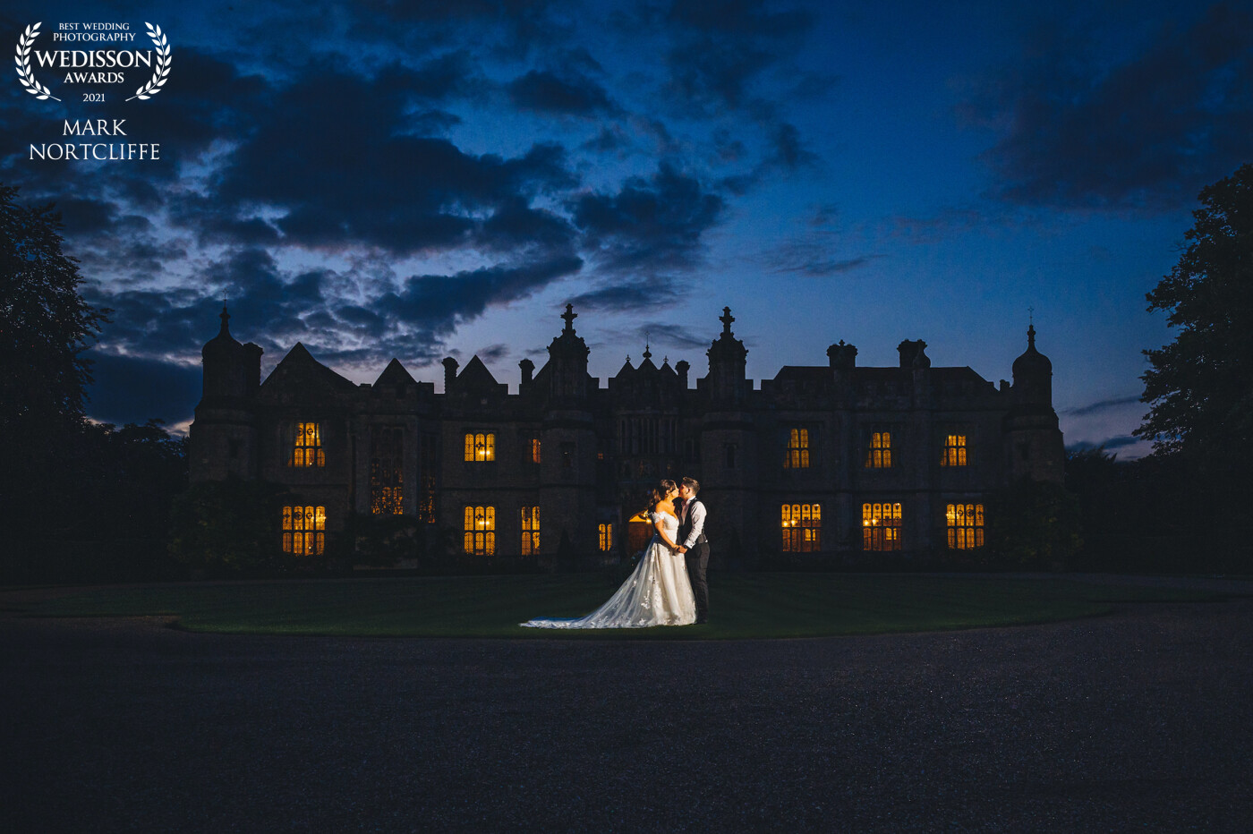 One of the last photographs taken outside on the day of Bethany and Jack's amazing wedding at Hengrave Hall before we headed inside to finish the night off in true style. Congratulations guys for having me along for the day. I had spotted this backdrop previously knowing it would be stunning when lit up at night. Such an amazing venue.