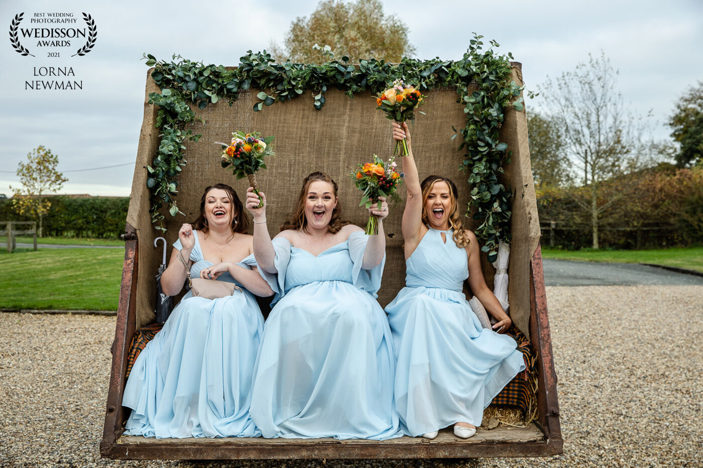 Milly & Sam's bridesmaids traveling in style to their wedding ceremony on the famous Godwick Hall wedding tractor in Norfolk, England. Everyone loves this part of the day at Godwick, and it makes a fantastic shot !!