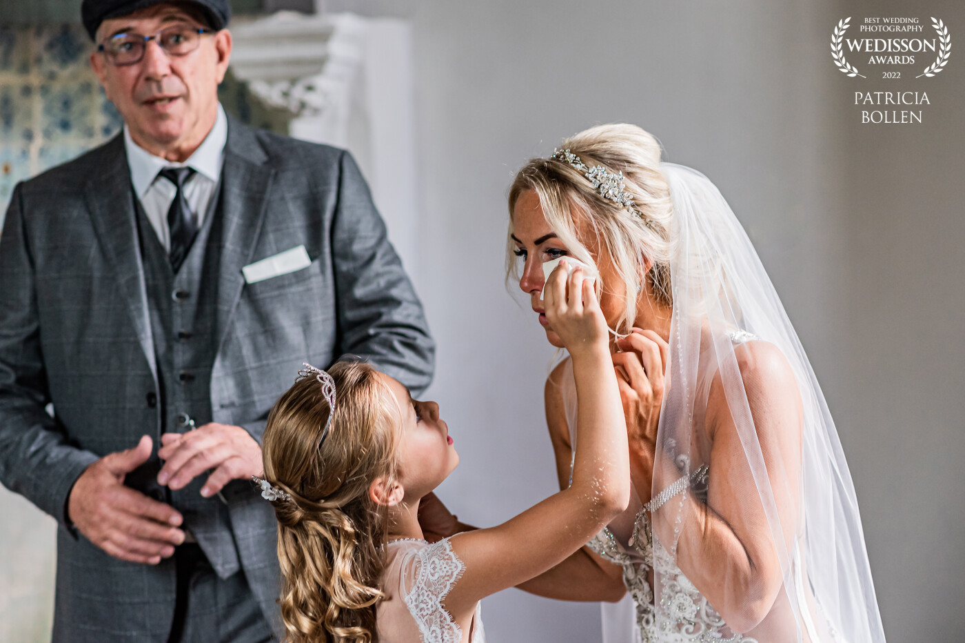 This beautiful bride just had the first look with her dad before he gave het away. The daughter of the bride helped to keep her mom's eyes dry