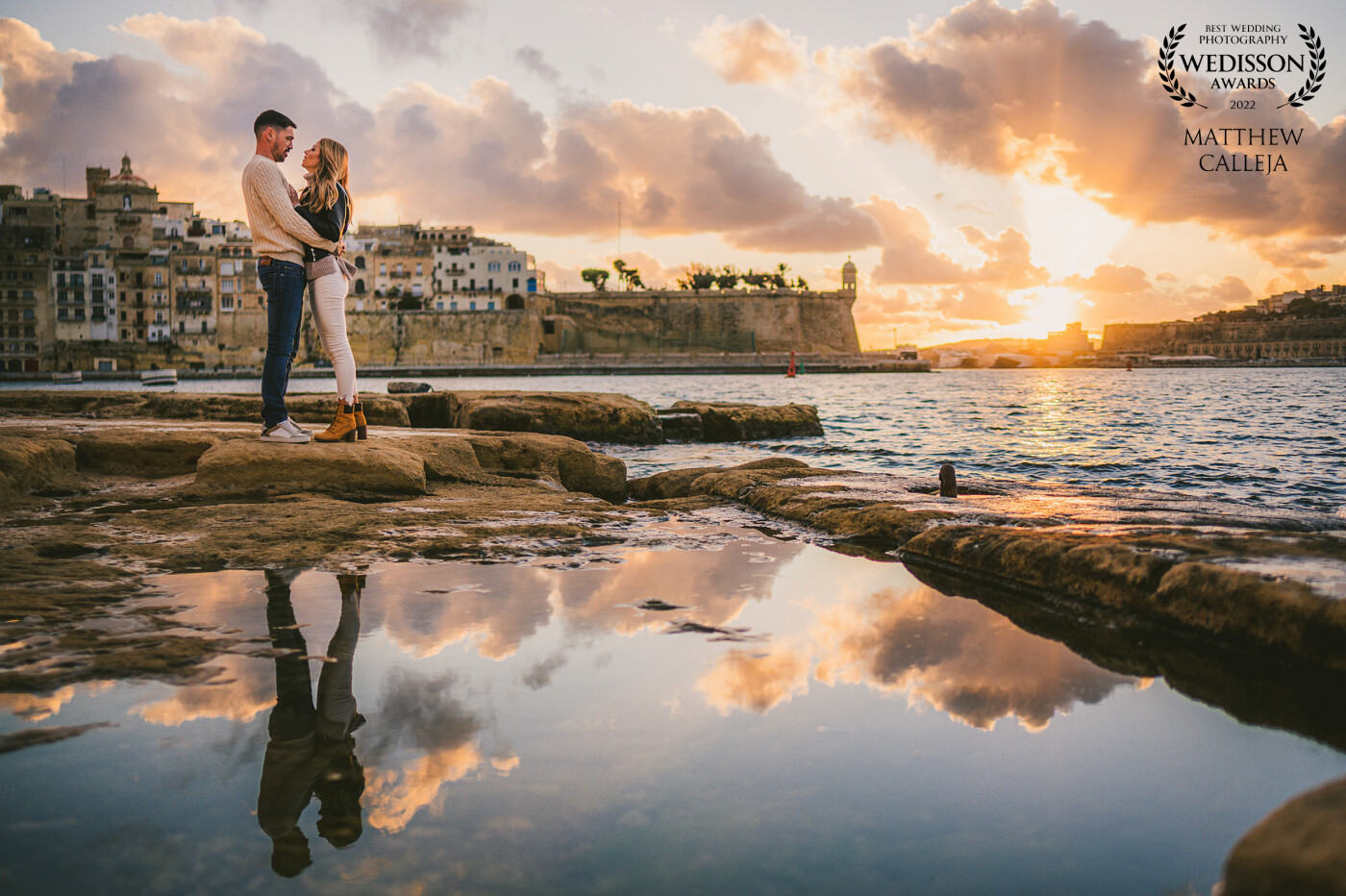 After a whole week of constant rain, we were lucky enough to have a great sunset during the pre-wedding, which is usually the case in Malta. The rain from previous days played in our favour creating the reflection which makes this image really pop out!