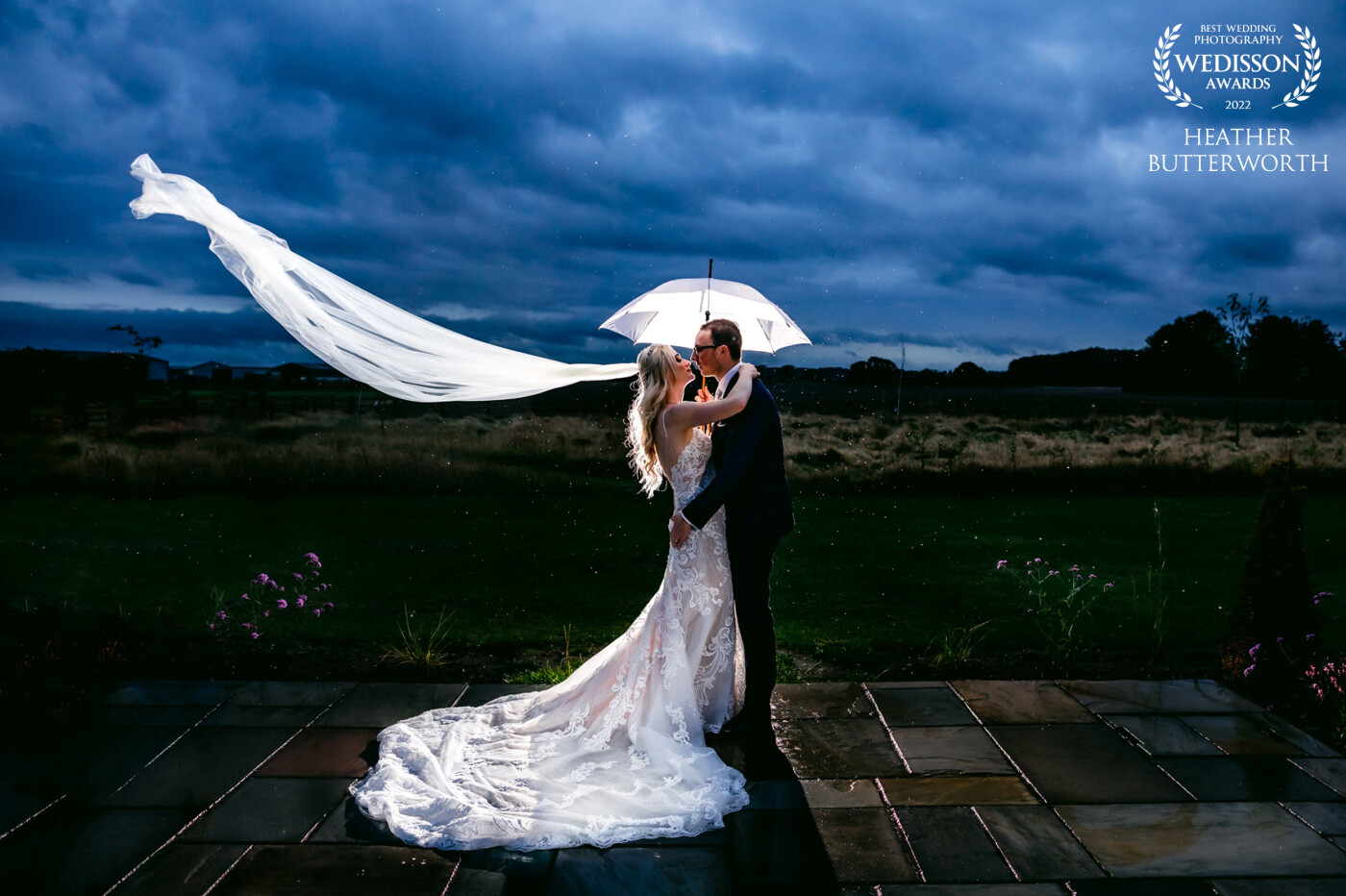 The weather was terrible at Katy and Ryan's stunning wedding at The Oakwood at Ryther in Yorkshire. I'd taken in door photos all day! But while the guests enjoyed the wedding breakfast I wanted to use the weather, together with some lighting to create a dramatic shot making the most of the rain, cloud and the scenery, so I set this shot up and grabbed Katy and Ryan for 2 minutes to create this beautiful atmospheric shot.