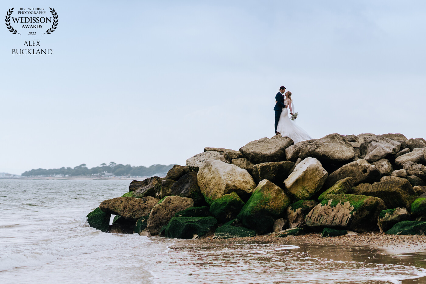 Whilst capturing portraits on the beach with this couple, I noticed a jetty that would serve as a great spot for the couple to pose, together with the sea and rocks it turned into a wonderful scene for this romantic photo!