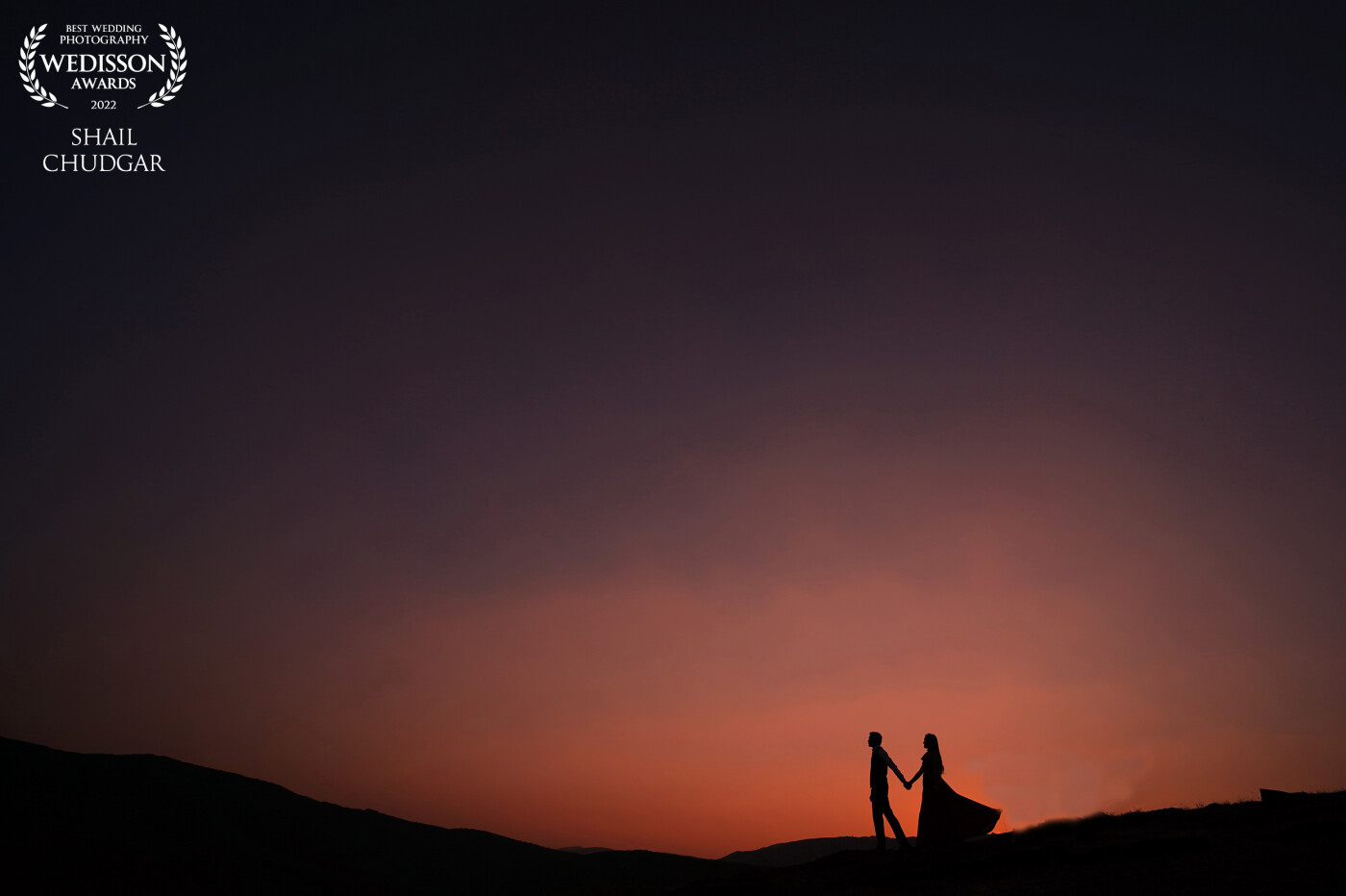 This was the end of the day and the last shot after sunset and the sky was to die for! I just told the couple to walk hand in hand on this hill and got a series of fantastic silhouettes.
