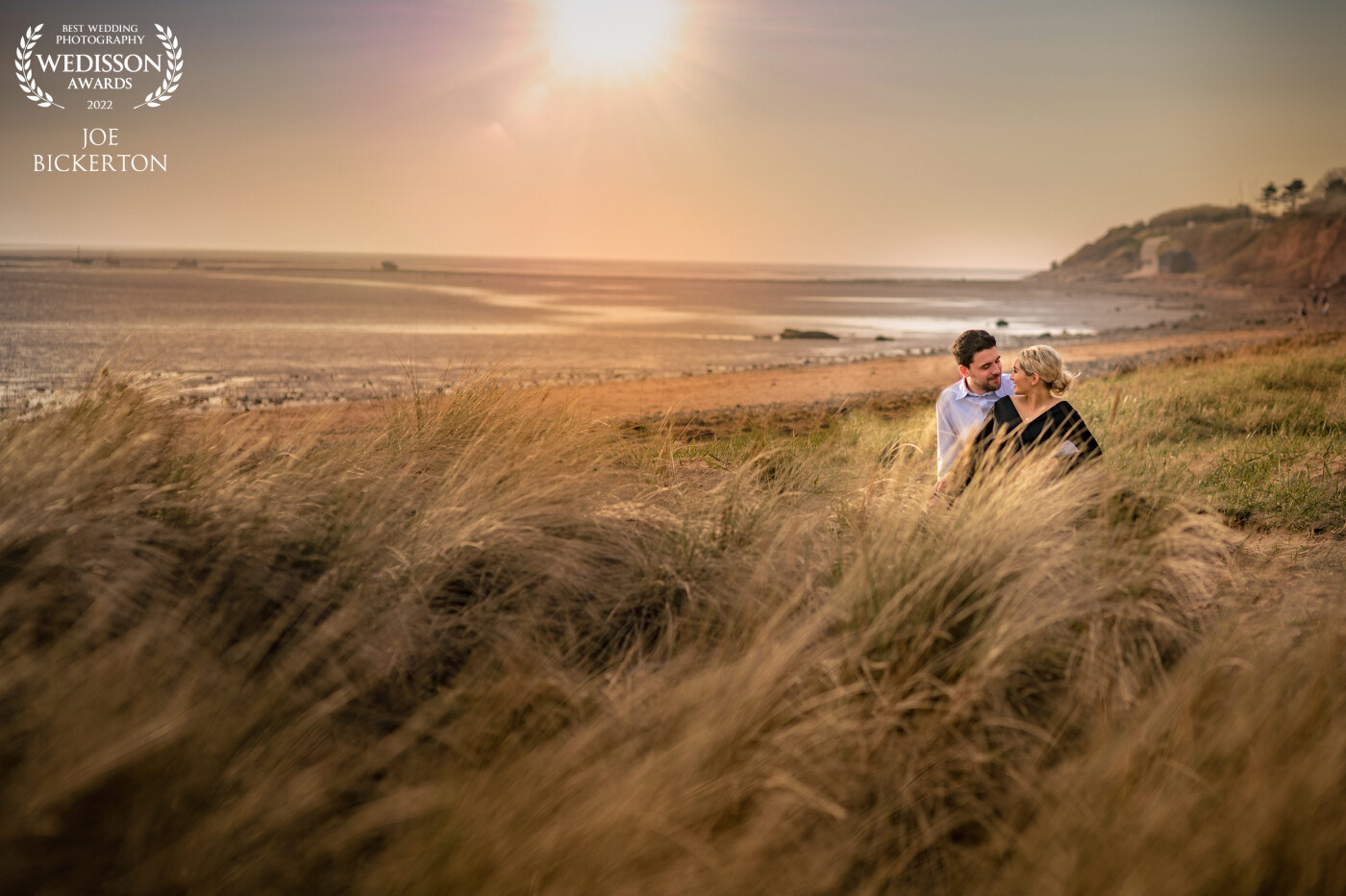 Amy & Tom's pre-wedding shoot.  This beach on the Wirral, England has incredible sunsets.  Amy & Tom are lit by an OCF flash - probably on 1/128 power with a mag-grid, allowing me to lower the exposure of the overall image to try and preserve some of the sun's highlights.
