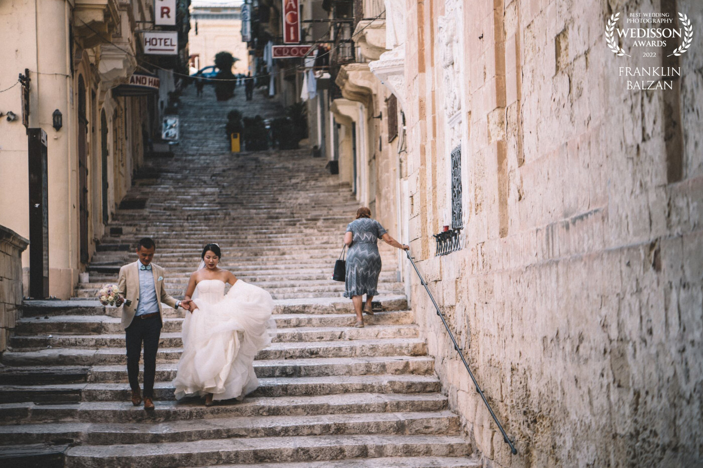 A quiet moment of movement in our capital city of Valletta... As soon as I saw the elderly lady going up the stairs I noted the elegance of the wedding couple contrasting so well with the old city vibes.