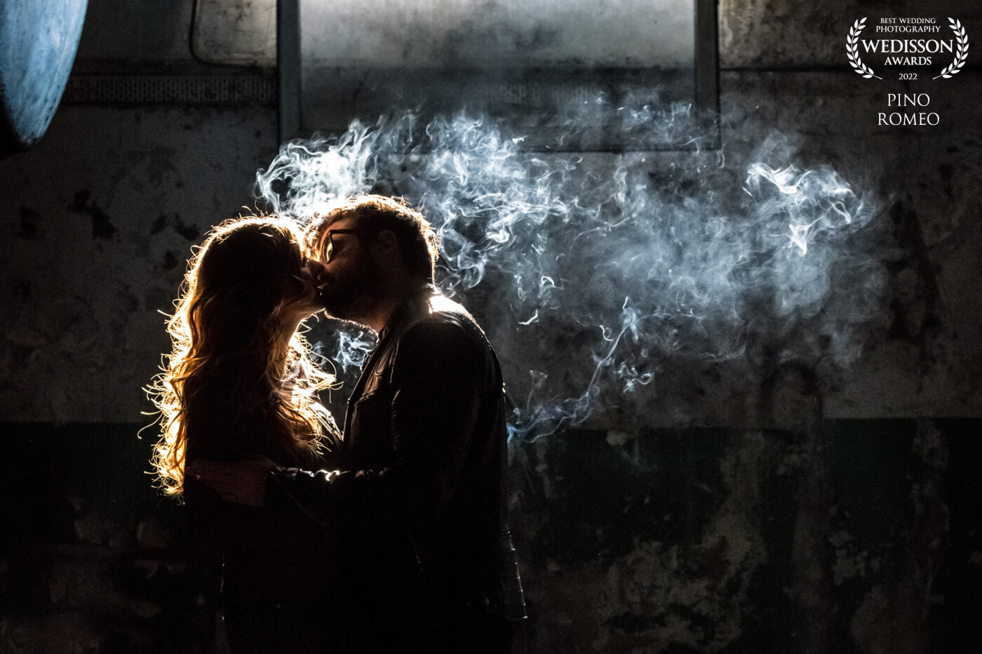A few months before their wedding, Vaïssa and Benoit met in an old factory for an engagement session. It was a very cold and bright winter day.  The condensation of their breath, in the light of the window well, was like a wild smoke.