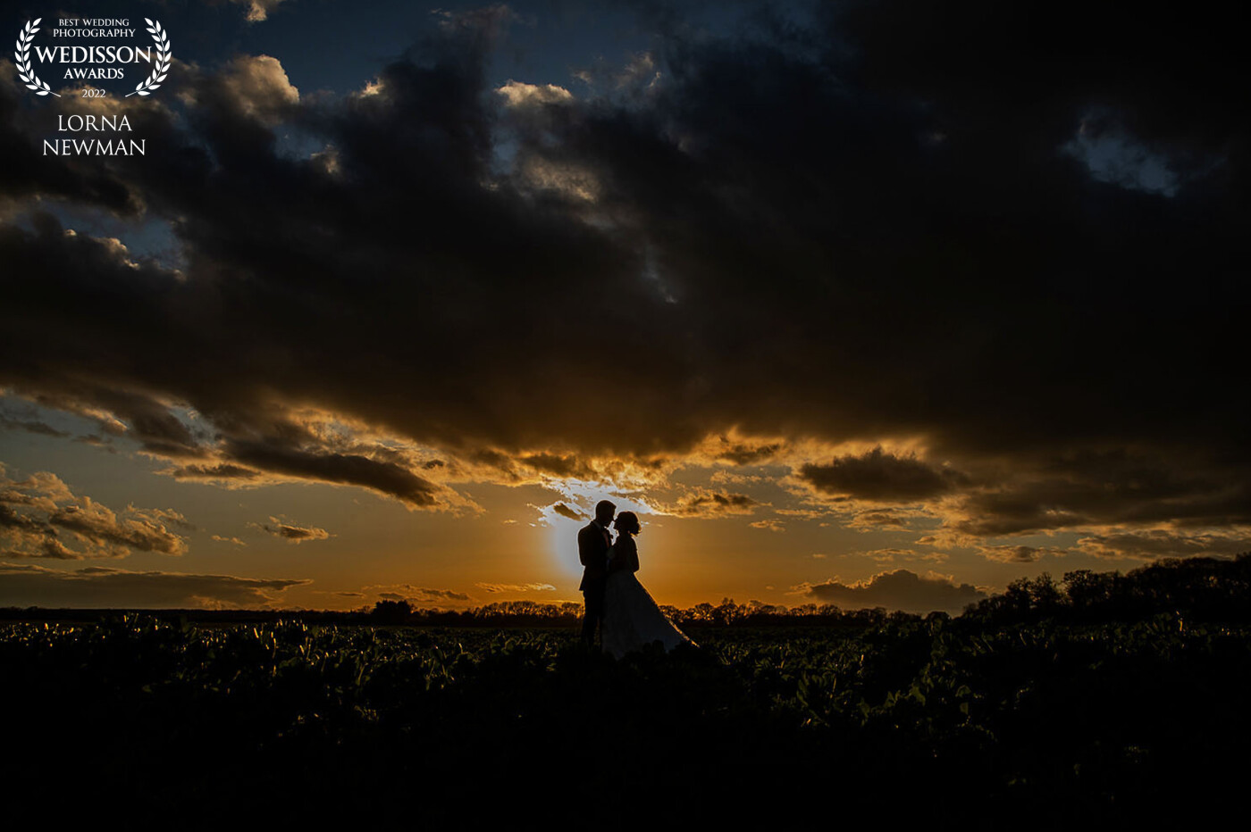 Katy & Andy at Bassmead manor barn as the sun is setting.