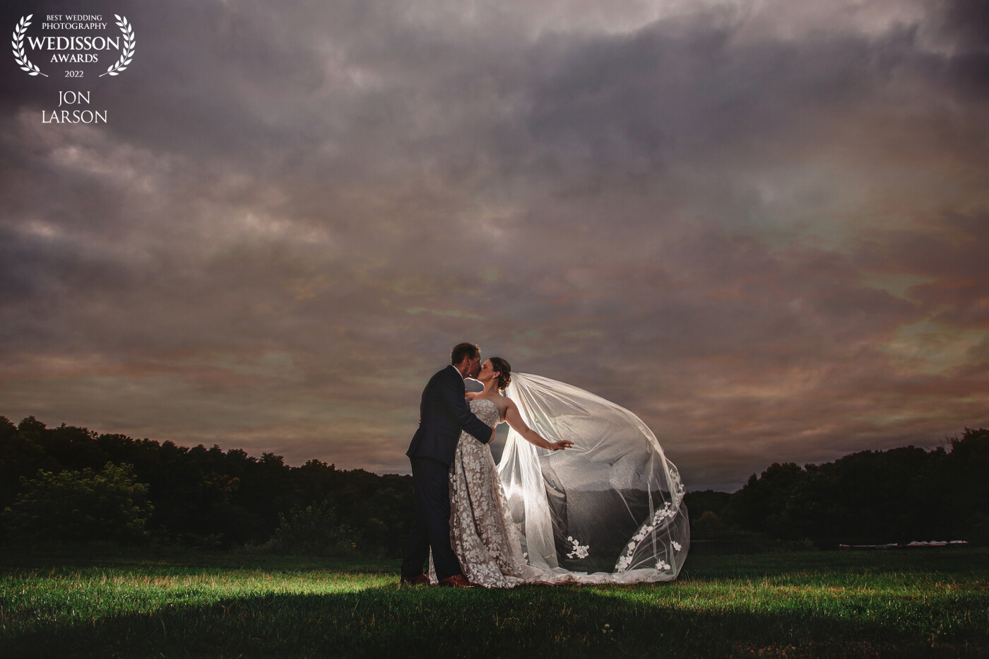 The sky was very ominous looking and the sun was fading fast! Grabbing the newlyweds I was able to create for them under another masterpiece sky. The brides veil was absolutely beautiful and had to be a part of this shot.