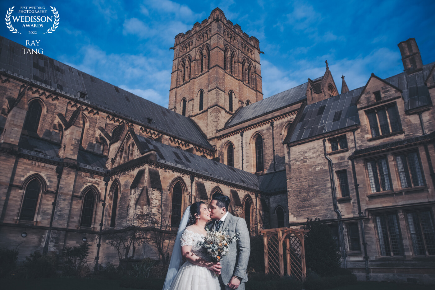 This awesome couple got married in the amazing St John's Cathedral in Norwich. The whole wedding including ceremony and reception took place on the grounds of the venue. I had to grab them out after the wedding breakfast before it was too dark,  The Cathedral was lit by the sunset and I lighted the couple with the AD200 to create this shot.