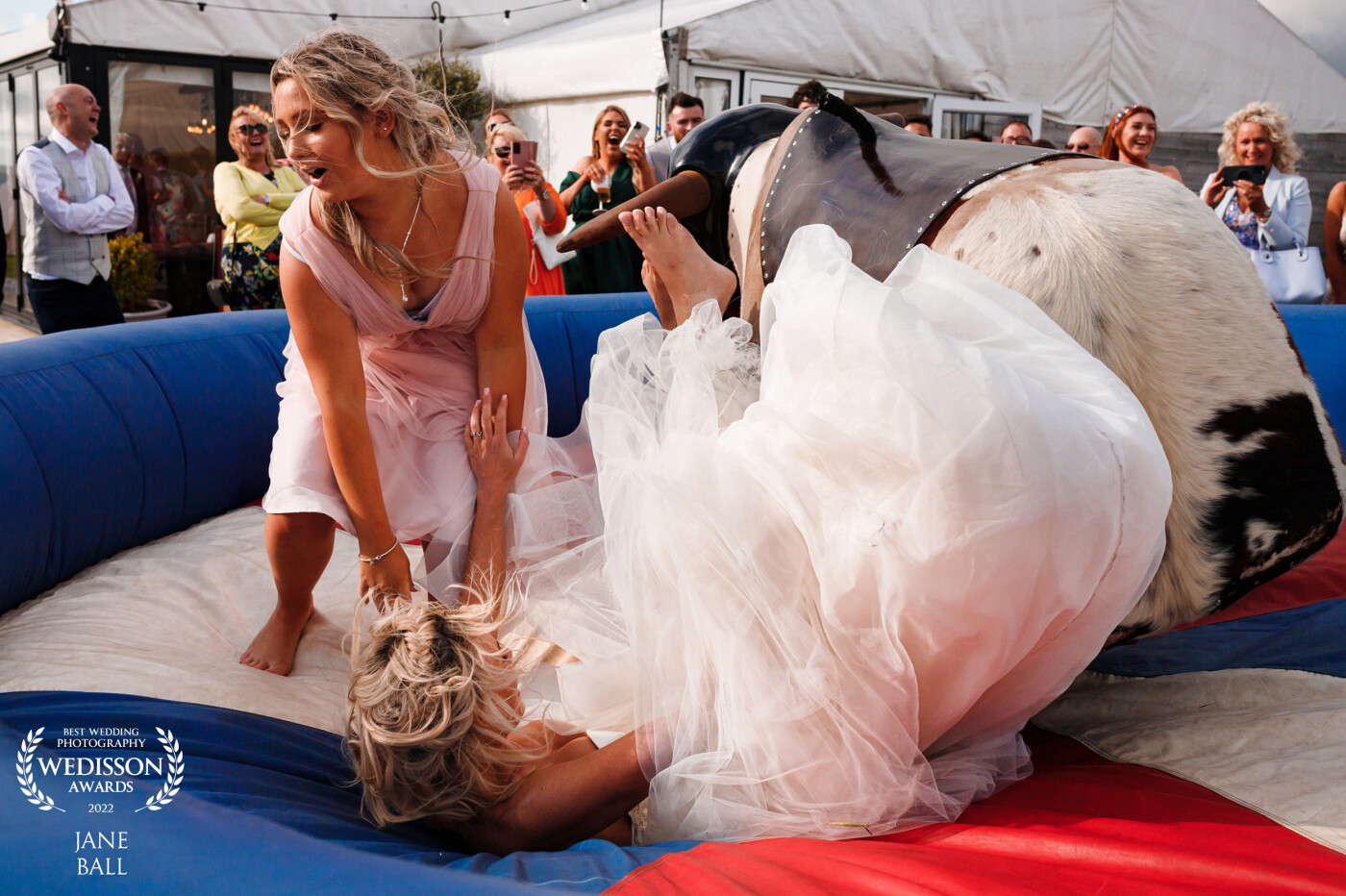 I knew this wedding was going to fun filled when the bride told me they were having a rodeo bull at the reception and it certainly proved to be the case when almost everyone in the wedding party had a go!<br />
I was definitely in the right place at the right time to get this shot as the bride came flying off it almost knocking one of her bridesmaids over in the process.