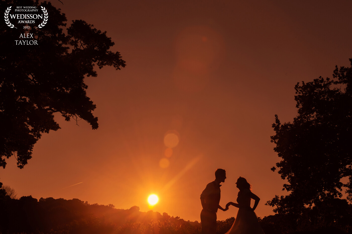 Sunset on Kristina and Caleb's wedding day at The White Hart Inn in Alferton, Derbyshire. <br />
<br />
The sky was vibrant and glowing and I couldn't resist capturing a stunning silhouette as the sun came down in the perfect place between the trees.