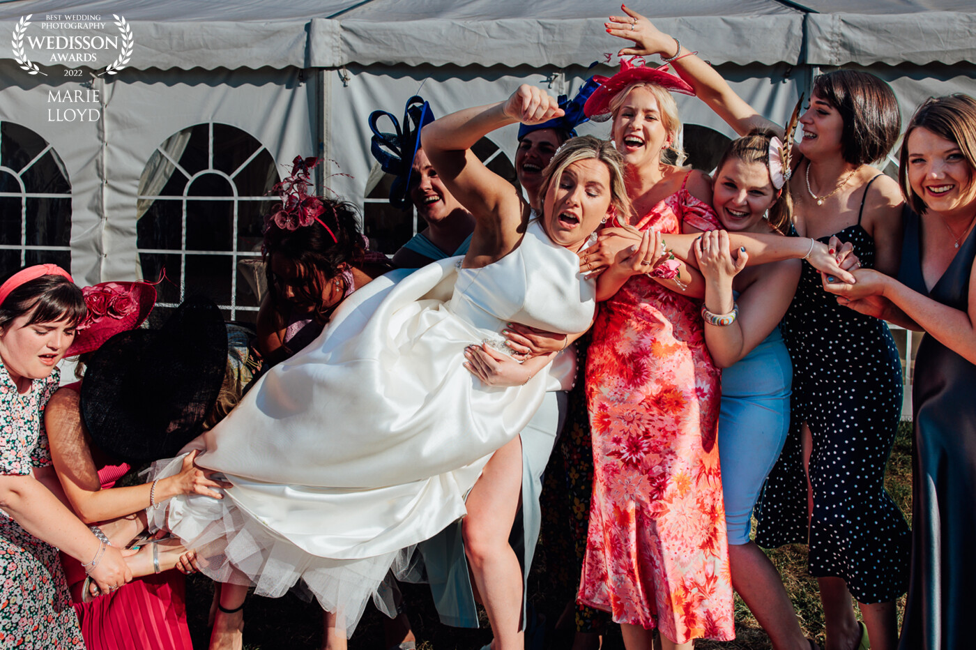Bride being put down after her photograph of being picked up by some slightly intoxicated friends and bridesmaids! She began to panic that they may frop her!