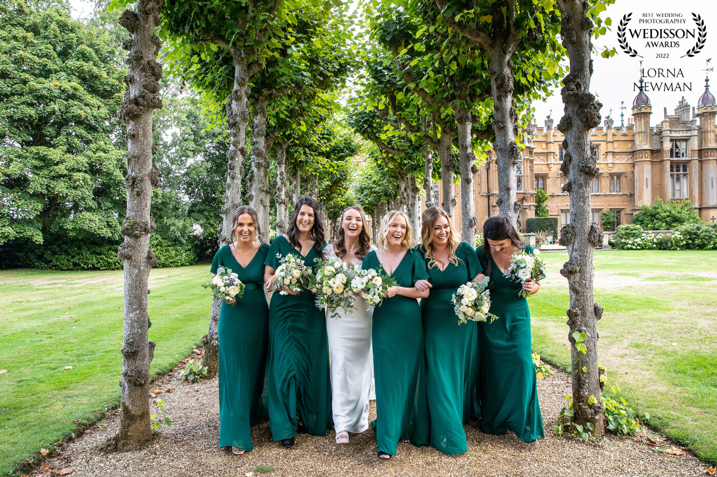 A shot from Sarah & Ally’s amazing wedding at Knebworth House, a fun shot of Sarah with her bridesmaids with Knebworth house in the background.