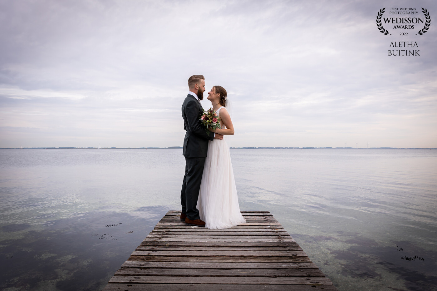 During the photoshoot of this bridal couple we specially drove to a small dock at the coast of one of the islands of Zeeland (The Netherlands). It was so quiet and serene there. The water so clear and still. Together with this lovely newlyweds made this a fantastic moment.